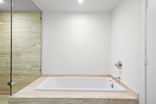 full bath with a stall shower, recessed lighting, and a bath