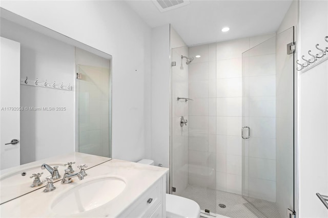 bathroom with recessed lighting, toilet, visible vents, a shower stall, and vanity