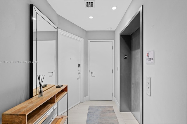 corridor featuring elevator, visible vents, and recessed lighting