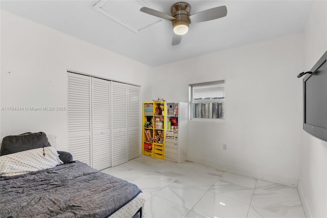 bedroom featuring ceiling fan, a closet, and marble finish floor