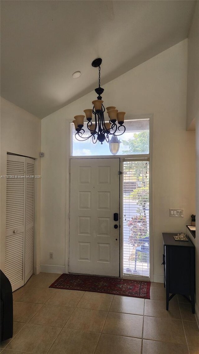 6365 NW 77th Pl, Parkland, FL 33067 - tiled entryway featuring vaulted ceiling and a chandelier