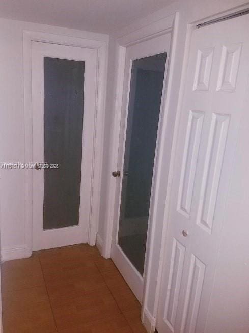 hallway featuring light tile patterned flooring
