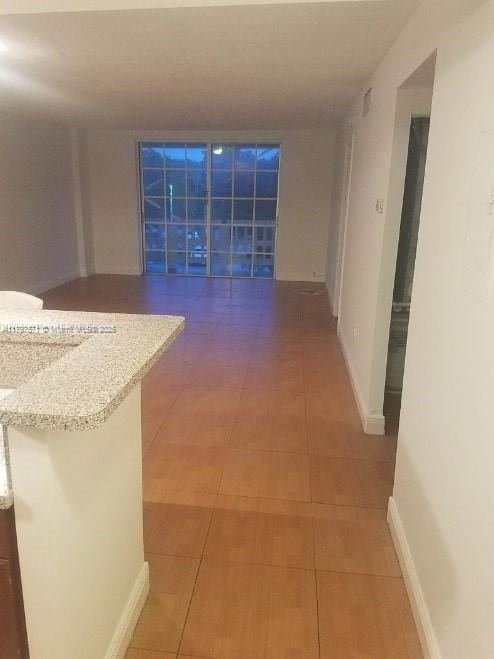 hallway with light tile patterned floors