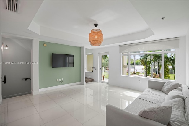 18445 NE 27th Pl, Aventura, FL 33160 - living room featuring a tray ceiling, baseboards, light tile patterned floors, and visible vents