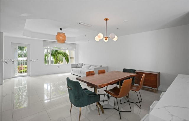 18445 NE 27th Pl, Aventura, FL 33160 - dining space with light tile patterned floors, a raised ceiling, and an inviting chandelier
