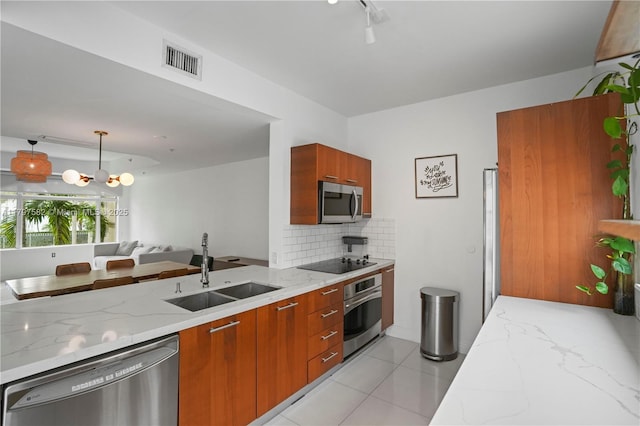 18445 NE 27th Pl, Aventura, FL 33160 - kitchen featuring brown cabinets, a sink, visible vents, modern cabinets, and appliances with stainless steel finishes
