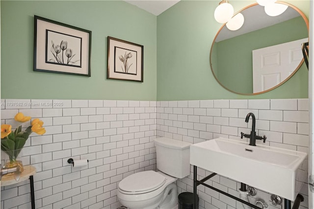 18445 NE 27th Pl, Aventura, FL 33160 - bathroom with toilet, tile walls, wainscoting, and a sink