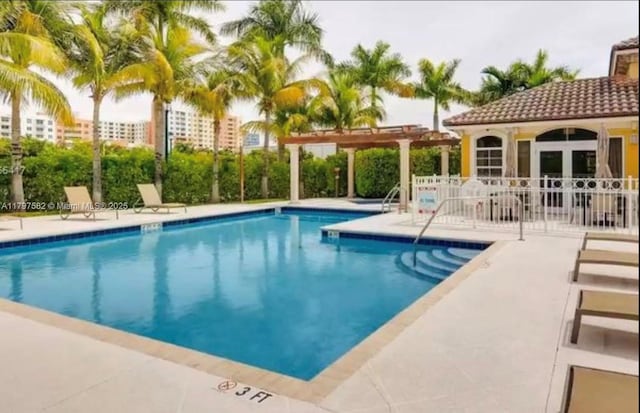 18445 NE 27th Pl, Aventura, FL 33160 - community pool with a patio area, a pergola, and fence