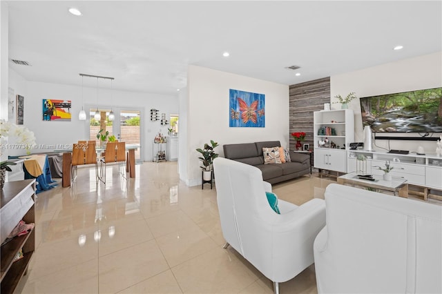 living room with light tile patterned floors, visible vents, baseboards, and recessed lighting
