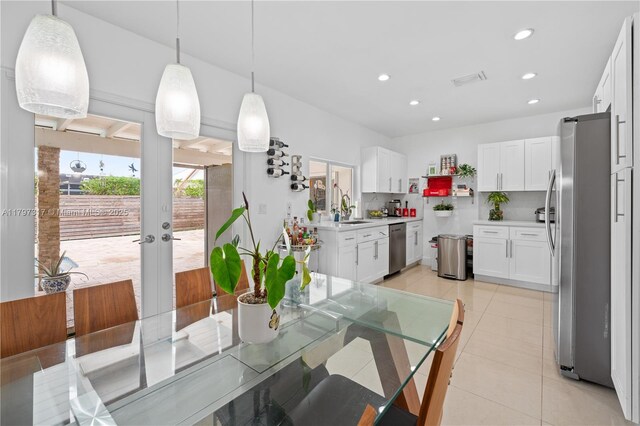 dining room featuring visible vents, french doors, light tile patterned floors, and recessed lighting