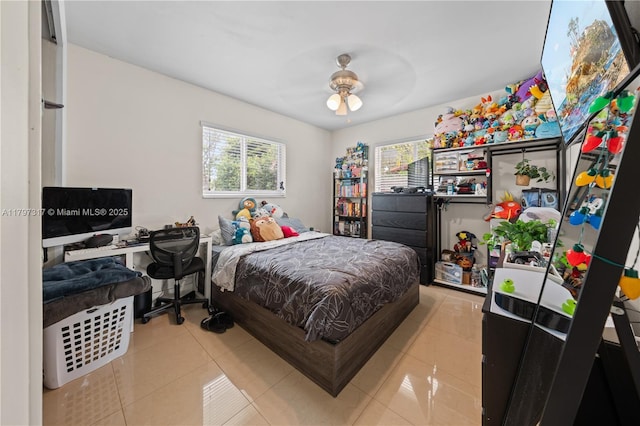 bedroom featuring multiple windows, tile patterned flooring, and ceiling fan
