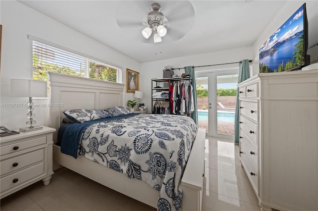 bedroom featuring light tile patterned flooring, multiple windows, french doors, and access to exterior