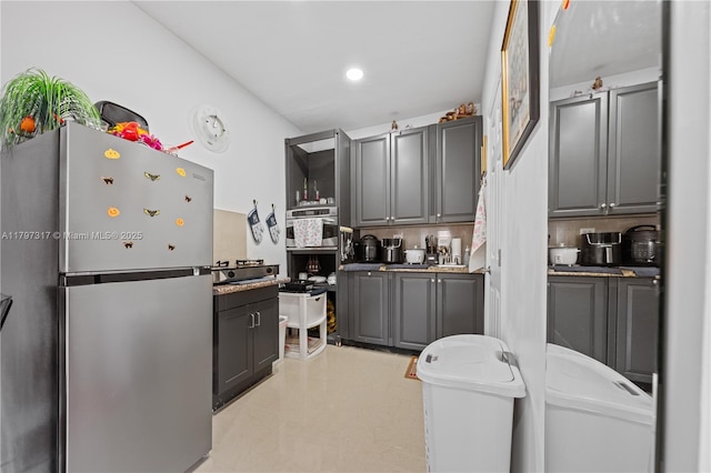 kitchen featuring freestanding refrigerator, recessed lighting, and gray cabinets