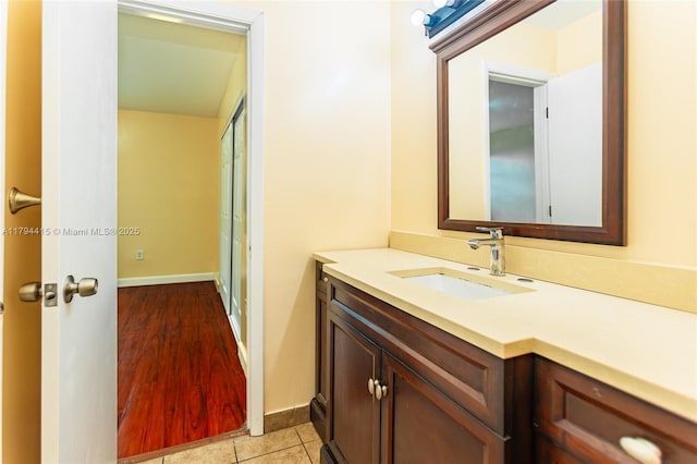 bathroom featuring tile patterned floors, baseboards, and vanity