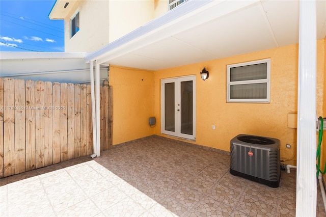 view of patio / terrace with cooling unit and fence