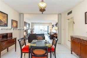 dining area with light tile patterned floors and visible vents