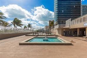 view of pool with a hot tub