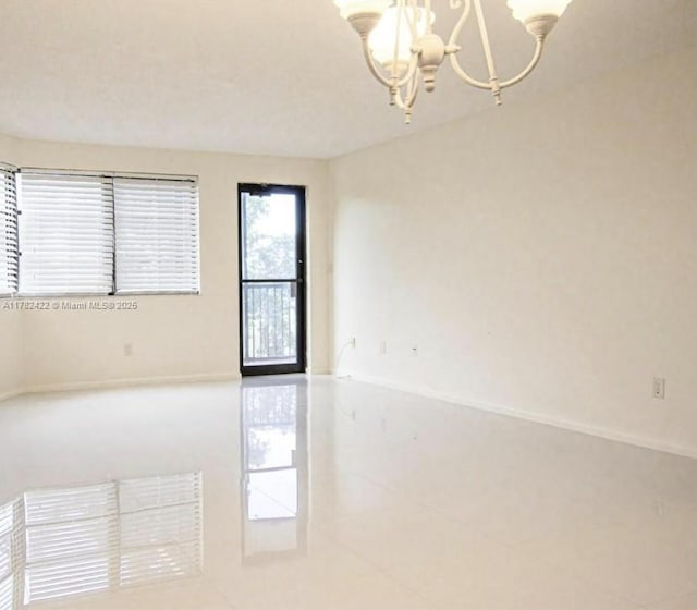 20850 San Simeon Way Unit 408-5, Miami, FL 33179 - empty room with an inviting chandelier and tile patterned floors
