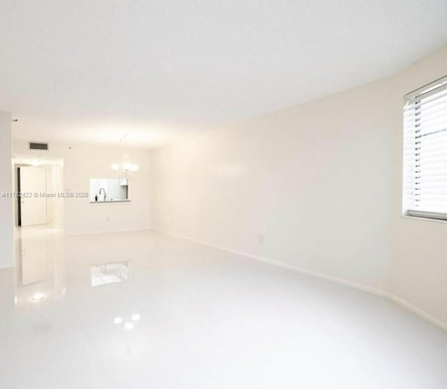20850 San Simeon Way Unit 408-5, Miami, FL 33179 - unfurnished room featuring baseboards, a chandelier, and visible vents
