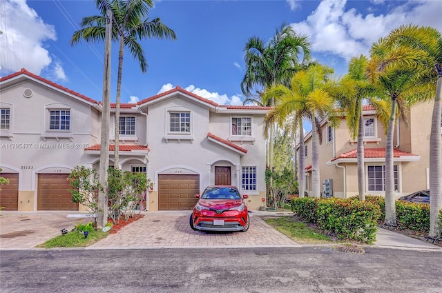 21133 NW 14th Pl, Miami Gardens, FL 33169 - mediterranean / spanish-style home featuring decorative driveway, a tile roof, stucco siding, and a garage