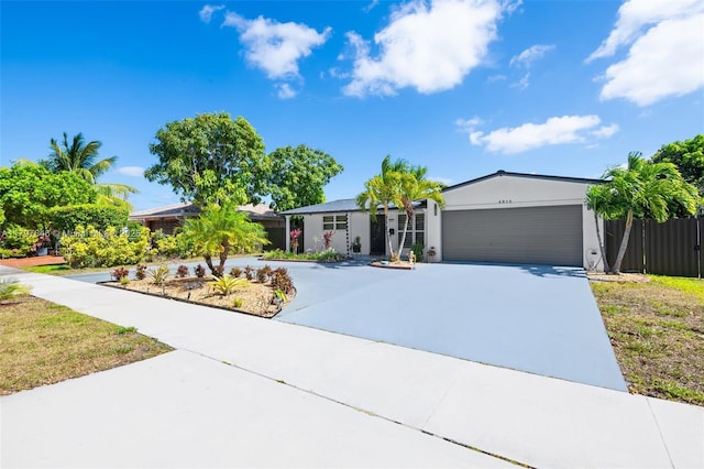 4912 Taft St, Hollywood, FL 33021 - ranch-style house featuring stucco siding, driveway, and a garage
