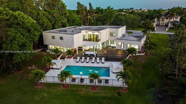 back of house featuring outdoor dining area, a fenced in pool, a patio, stairs, and a fenced backyard