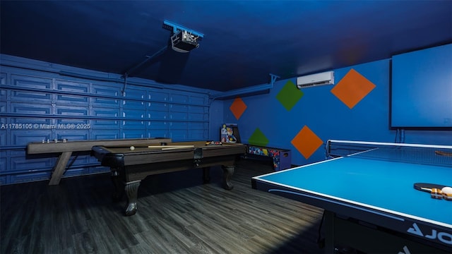 recreation room with pool table, a wall mounted AC, and wood finished floors