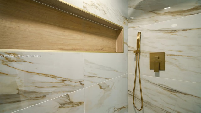 details featuring a marble finish shower
