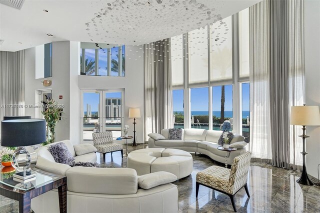 17201 Collins Ave Unit 1605, Sunny Isles Beach, FL 33160 - living area with a high ceiling, plenty of natural light, a water view, and marble tiled floors