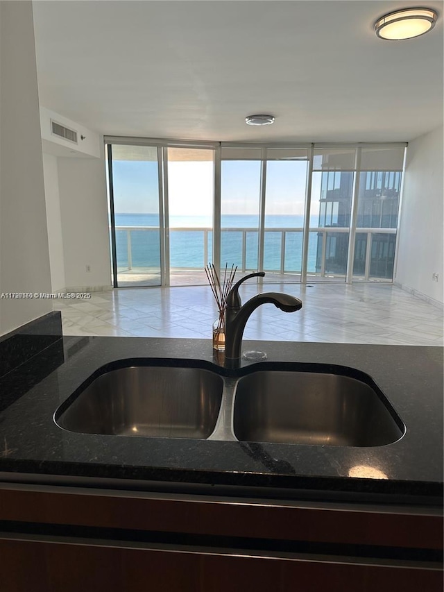 17201 Collins Ave Unit 1605, Sunny Isles Beach, FL 33160 - kitchen view of a sink, dark stone counters, and a water view
