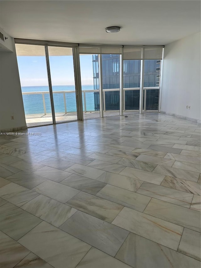 17201 Collins Ave Unit 1605, Sunny Isles Beach, FL 33160 - spare room with expansive windows and a water view