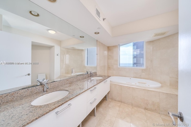 17201 Collins Ave Unit 1605, Sunny Isles Beach, FL 33160 - full bathroom with a garden tub, double vanity, and tile patterned floors