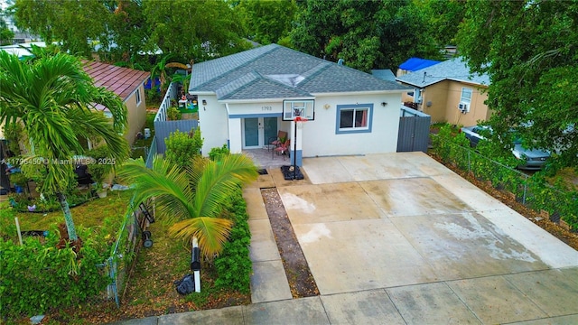1793 NW 93rd Ter, Miami, FL 33147 - bungalow featuring driveway, stucco siding, roof with shingles, and fence private yard