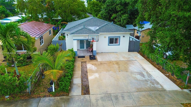 1793 NW 93rd Ter, Miami, FL 33147 - bungalow with roof with shingles, concrete driveway, stucco siding, and fence