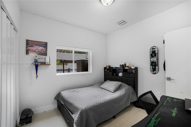 1793 NW 93rd Ter, Miami, FL 33147 - tiled bedroom featuring baseboards, a closet, and visible vents