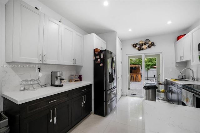 1793 NW 93rd Ter, Miami, FL 33147 - kitchen with a sink, tasteful backsplash, recessed lighting, dark cabinetry, and stainless steel fridge with ice dispenser