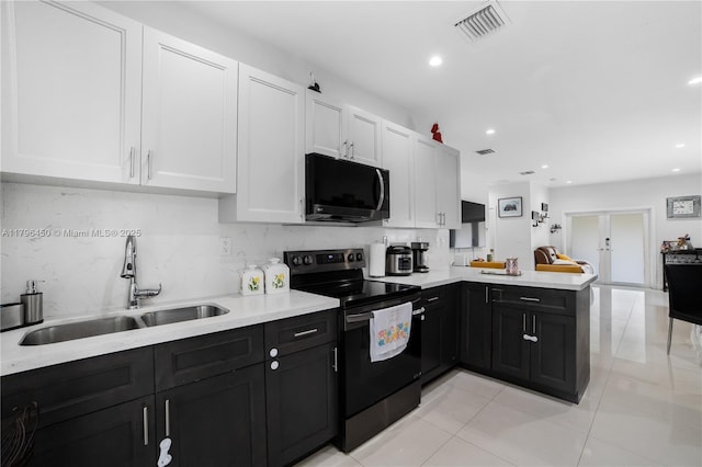 1793 NW 93rd Ter, Miami, FL 33147 - kitchen with a peninsula, a sink, white cabinets, electric stove, and light countertops