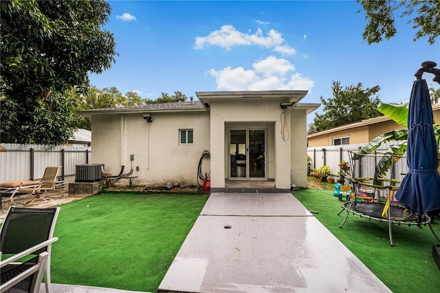 1793 NW 93rd Ter, Miami, FL 33147 - back of property with a patio area, stucco siding, fence, and a lawn