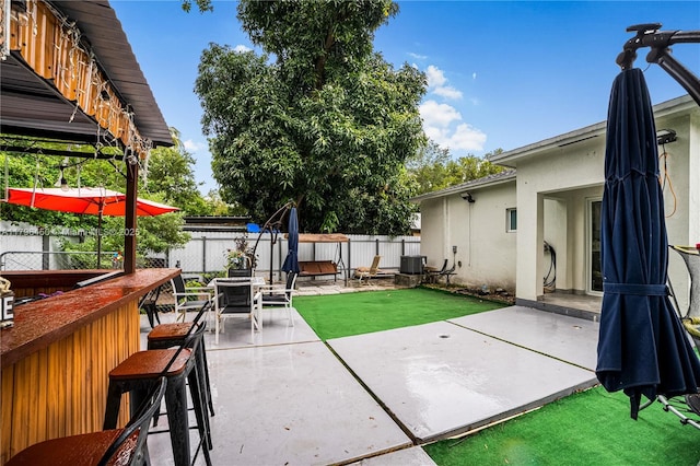 1793 NW 93rd Ter, Miami, FL 33147 - view of patio with a fenced backyard, outdoor dry bar, and central AC