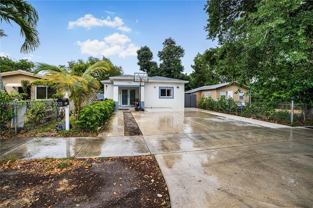 1793 NW 93rd Ter, Miami, FL 33147 - bungalow featuring concrete driveway, stucco siding, french doors, and fence