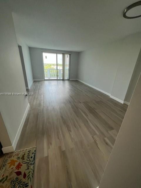 interior space with baseboards and wood finished floors