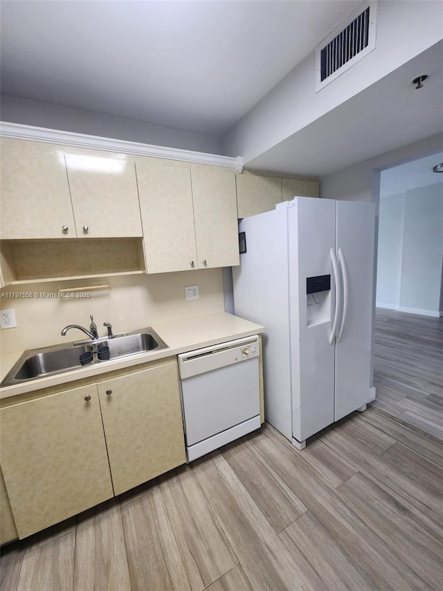919 Hillcrest Dr Unit 611, Hollywood, FL 33021 - kitchen featuring white appliances, a sink, light countertops, light wood-type flooring, and cream cabinetry
