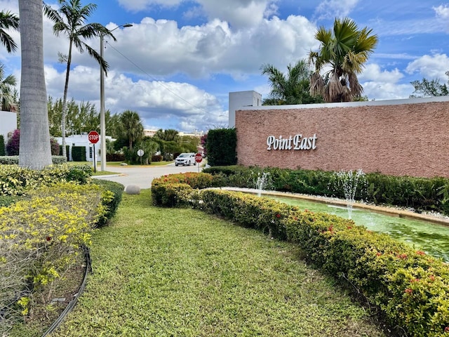 community sign featuring a lawn