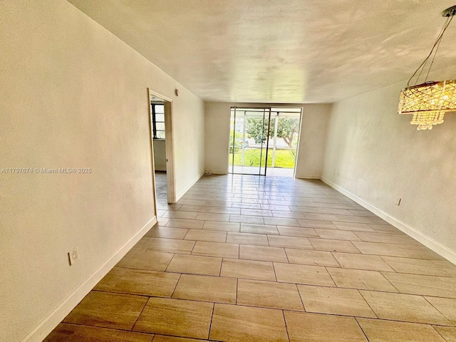 unfurnished room featuring baseboards