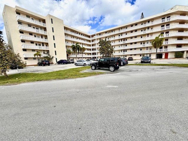 view of building exterior with uncovered parking