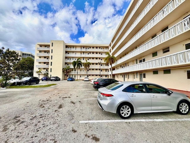 view of building exterior featuring uncovered parking