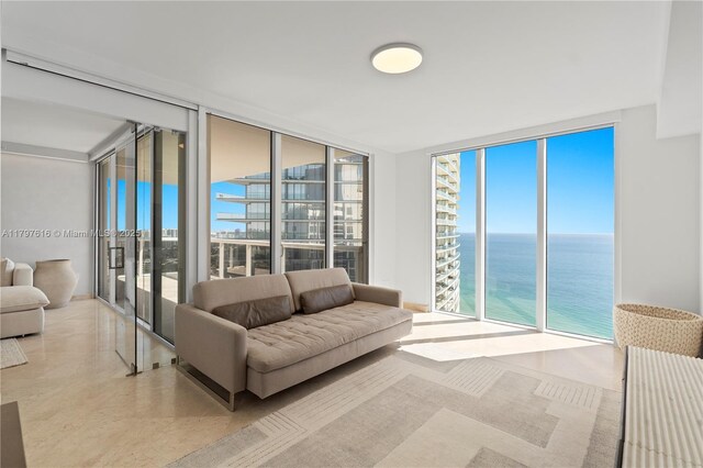 18911 Collins Ave Unit 3307, Sunny Isles Beach, FL 33160 - living area with a wall of windows, a water view, and tile patterned floors