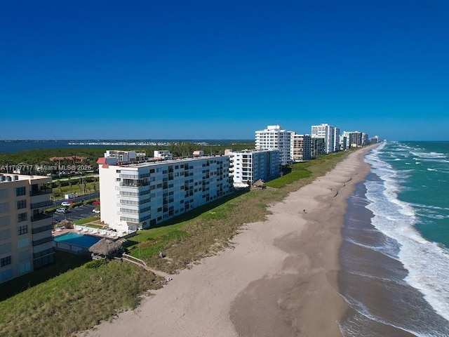 birds eye view of property with a view of the beach and a water view