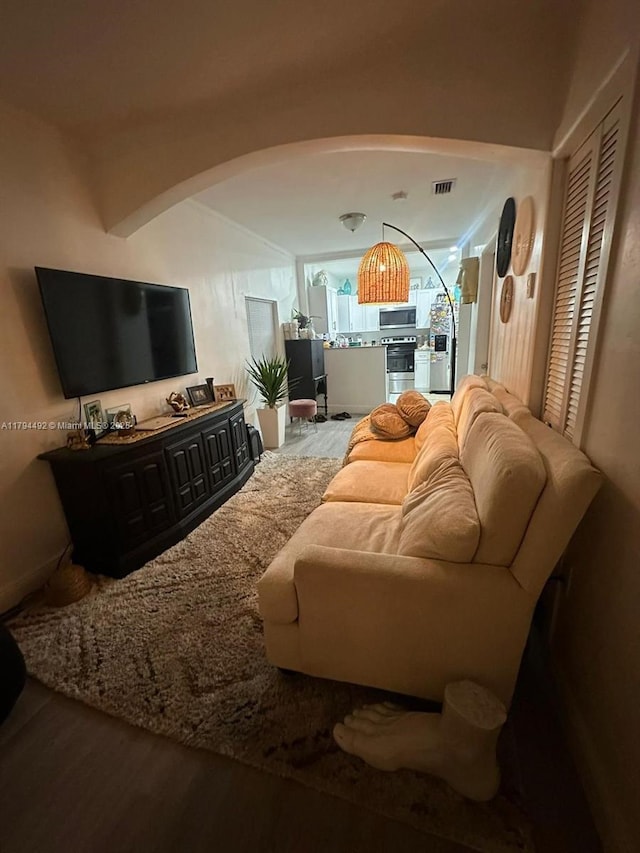 1874 NW 65th St, Miami, FL 33147 - living area featuring arched walkways, visible vents, and wood finished floors