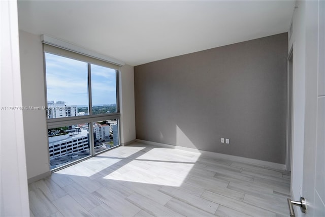 1010 SW 2nd Ave Unit 1703, Miami, FL 33130 - spare room with baseboards, a view of city, and expansive windows